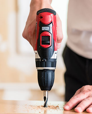 Craftsman or DIY man working with power drill